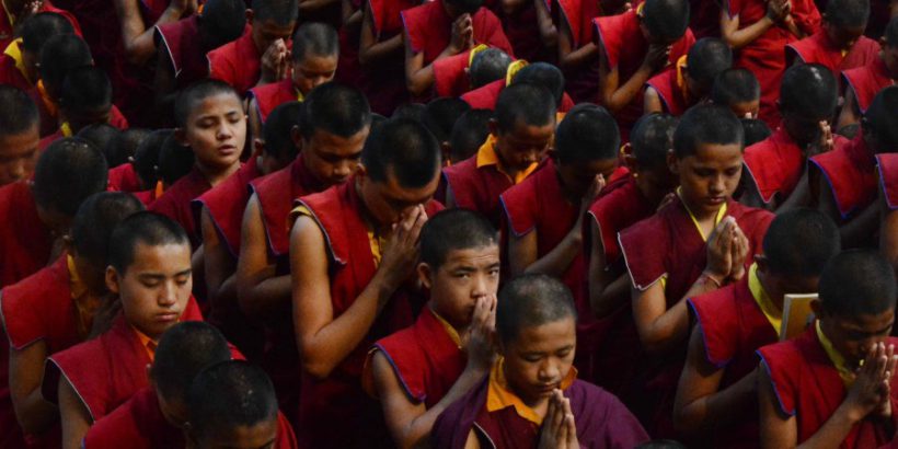 Nepalese novice Buddhist monks living at the Bodhgaya Tergar monastary offer prayers for the victims of an earthquake in Nepal at the Bodhgaya Mahabodhi temple in the Indian town of Bodhgaya on April 26, 2015. Powerful aftershocks rocked Nepal April 26, 2015, panicking survivors of a quake that killed more than 2,300 and triggering fresh avalanches at Everest base camp, as rescuers dug through rubble in the devastated capital Kathmandu. Terrified residents, many forced to camp out in the capital after the April 25, 2015, quake reduced buildings to rubble, were jolted by a 6.7-magnitude aftershock that compounded the worst disaster to hit the impoverished Himalayan nation in more than 80 years. AFP PHOTO / STR        (Photo credit should read STRDEL/AFP/Getty Images)