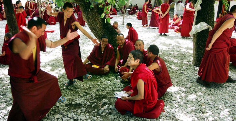 LHASA, CHINA - JULY 4:  (CHINA OUT) Monks take part in a daily debate at the Sera Monastery on July 4, 2006 in Lhasa, Tibetan Autonomous Region, China. The Sera Monastery is one of the 3 great monasteries of Tibet along with the Gadan and Drepung Monasteries. (Photo by China Photos/Getty Images)