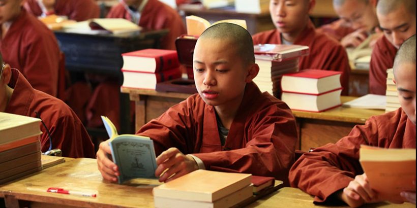 Young Buddhist monk Venerable Xing-Shuo recites an ancient Indian classic called "Ornament of Clear Realization" at the Moonlight International Academy in Little Sands, PE. (Great Enlightenment Buddhist Institute Society)